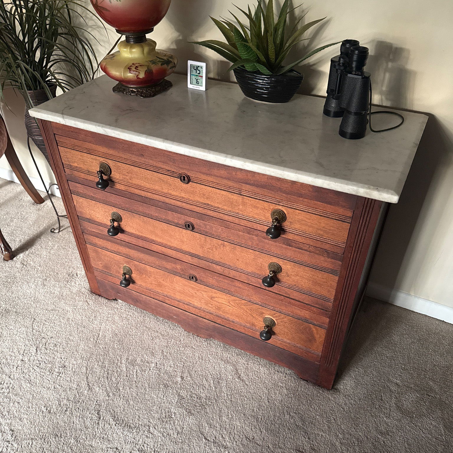 An antique walnut chest with a marble top, kept in the founder's family